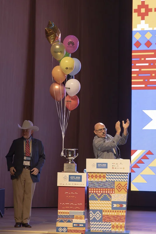 ICPC trophy and sponsor balloons on stage in Baku