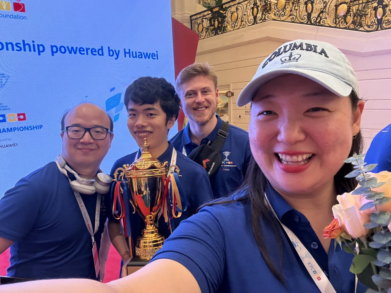 Christian Lim with ICPC Challenge participants and the championship trophy in Dongguan in 2024